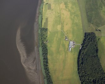 Oblique aerial view centred on the cropmarks of the enclosures and field boundaries with the farmhouse, farmsteading and remains of the castle adjacent, taken from the WSW.