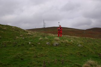 View of cairn from SE; Ms G. Brown (RCAHMS) in photo