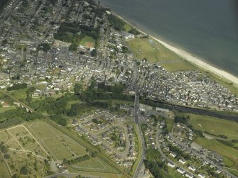 Oblique aerial view of the town centred on the road bridge, railway viaduct and cemetery, taken from the ESE.