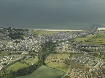 General oblique aerial view of the town centred on the road bridge, railway viaduct and cemetery, taken from the SE.