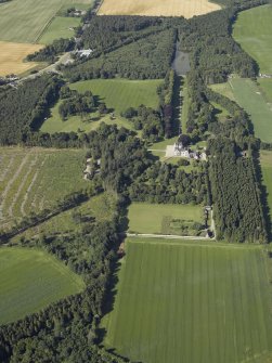 Oblique aerial view centred on the castle, country house and walled garden with the lodge adjacent, taken from the NE.