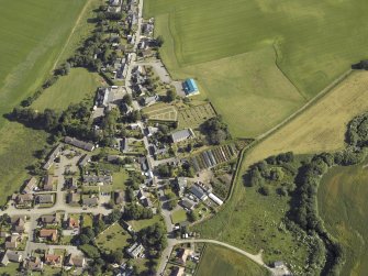 Oblique aerial view centred on the church and the burial ground, taken from the SW.