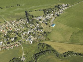 Oblique aerial view centred on the church and the burial ground, taken from the SE.