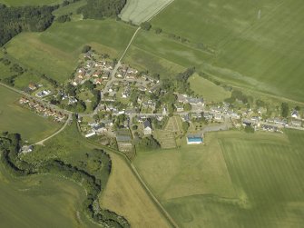 General oblique aerial view of the village, centred on the church and the burial ground, taken from the E.