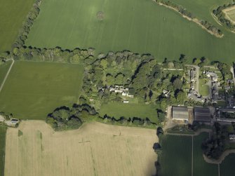 Oblique aerial view centred on the country house with the farmhouse, farmsteading and cottage adjacent, taken from the ESE.