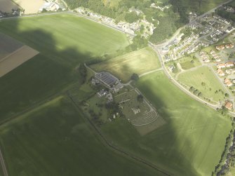 General oblique aerial view centred on the remains of the abbey and burial-ground and the farmsteading, taken from the E.