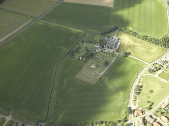 General oblique aerial view centred on the remains of the abbey and burial-ground and the farmsteading, taken from the NE.