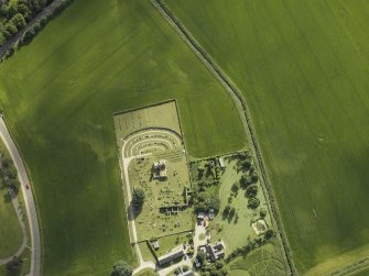 Oblique aerial view centred on the remains of the abbey and burial-ground, taken from the W.