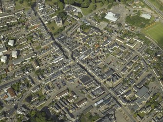 Oblique aerial view of the town centred on the tollbooth and town hall with the church and burial ground adjacent, taken from the E.