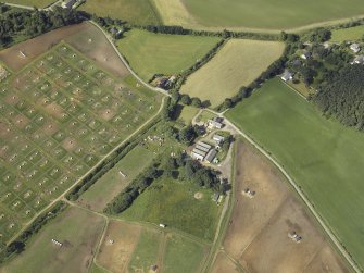 Oblique aerial view centred on the watermill and house with the pig farm adjacent, taken from the NNE.