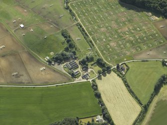 Oblique aerial view centred on the watermill and house with the pig farm adjacent, taken from the WNW.