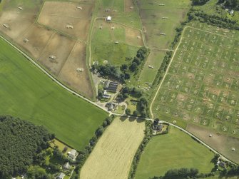 Oblique aerial view centred on the watermill and house with the pig farm adjacent, taken from the SW.