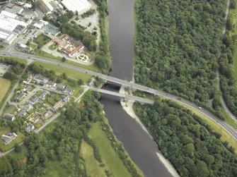 Oblique aerial view centred on the road bridges and tollhouse, taken from the SSW.