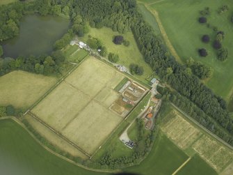 Oblique aerial view centred on the walled gardens and the house, taken from the SE.