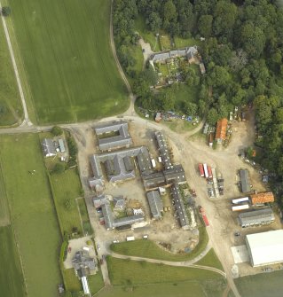 Oblique aerial view centred on the farmsteading, farmhouse and kennels, taken from the SSE.