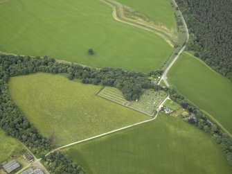 Oblique aerial view centred on the cemetery, lodge and remains of the burial-ground, taken from the NE.