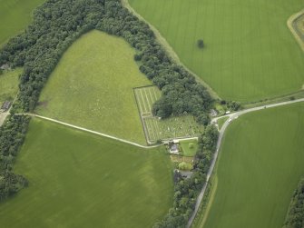 Oblique aerial view centred on the cemetery, lodge and remains of the burial-ground, taken from the NNW.