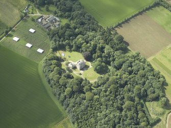 Oblique aerial view centred on the country house with the farmhouse and farmsteading adjacent, taken from the N.