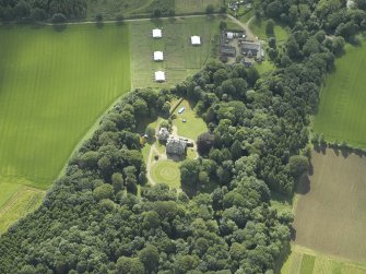 Oblique aerial view centred on the country house with the farmhouse and farmsteading adjacent, taken from the NW.