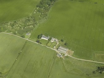 Oblique aerial view centred on the church, taken from the SE.