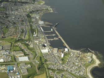 Oblique aerial view centred on the harbour with the boatyard adjacent, taken from the ENE.