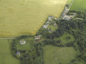 General oblique aerial view centred on the remains of the church, burial ground and tower-house, taken from the S.
