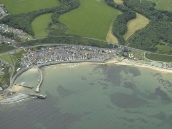 General oblique aerial view of the village centred on the harbour and the railway viaduct, taken from the NNE.
