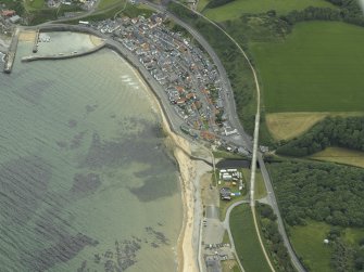 Oblique aerial view centred on the railway viaduct and road bridge with the harbour and village adjacent, taken from the WNW.