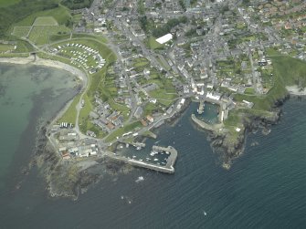 Oblique aerial view of the village centred on the harbours, taken from the N.