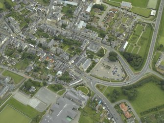 Oblique aerial view centred on the church with the school adjacent, taken from the WSW.