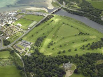 General oblique aerial view centred on the golf course with the country house in the foreground and the road bridge in the distance, taken from the SSW.