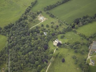 Oblique aerial view centred on the country house with the farmhouse adjacent, taken from the NW.