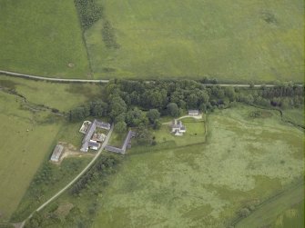 Oblique aerial view centred on the tower-house, farmhouse and farmsteading, taken from the WSW.