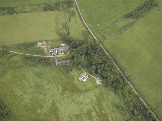 Oblique aerial view centred on the tower-house, farmhouse and farmsteading, taken from the SSW.