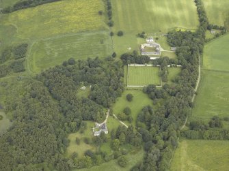 General oblique aerial view centred on the castle and walled garden with the farmhouse and farmsteading adjacent, taken from the S.