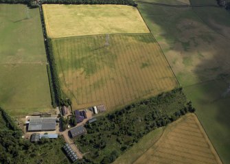 Oblique aerial view centred on the cropmarks of the possible barrow, taken from the WSW.