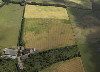 Oblique aerial view centred on the cropmarks of the possible barrow, taken from the SW.