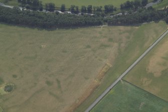 Oblique aerial view centred on the parchmarks of the possible barrows and quarries and the remains of the cairn, taken from the N.