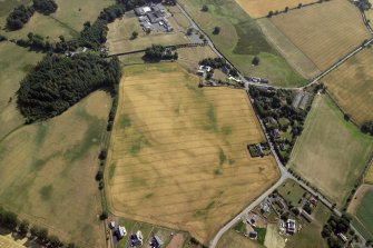 Oblique aerial view centred on the cropmarks of the enclosure, taken from the WSW.