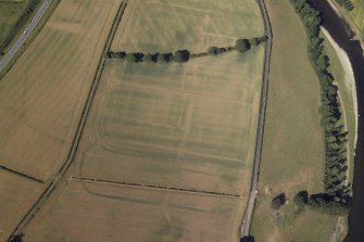 Oblique aerial view centred on the cropmarks of the Roman fort and fort annexes, taken from the ENE.