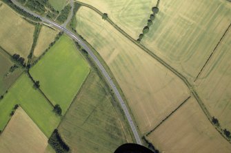 Oblique aerial view centred on the cropmarks of the possible fort annexe, taken from the SE.