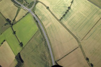 Oblique aerial view centred on the cropmarks of the possible fort annexe, taken from the ESE.