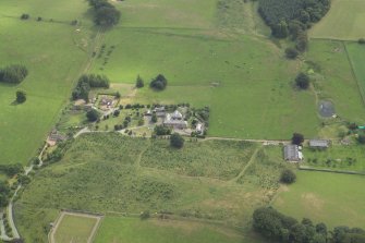 Oblique aerial view centred on the houses and the site of the house, taken from the WNW.