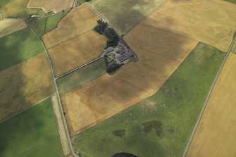 Oblique aerial view centred on the cropmarks of the rig and the farmhouse and farmsteading, taken from the ENE.