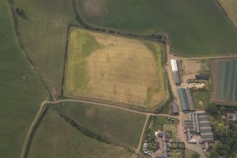 Oblique aerial view centred on the cropmarks of the possible ring-ditch and pits, taken from the E.