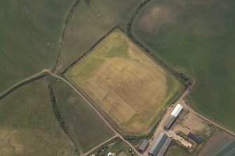 Oblique aerial view centred on the cropmarks of the possible ring-ditch and pits, taken from the NE.