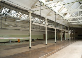 Interior. Office/Administrative block. Ground floor. View of modern cutting room (zone 3) from NW. This space has 10 bays and 9 columns creating 3 bays longitudinally. Columns are elegant cast-iron with bell capital in Tuscan style order of appearance, roof supported by wooden beams, roof glass, slate, wood and king-post with steel tie-bars.