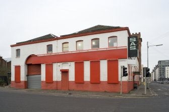 E side. View from ENE, Tradeston Street elevation showing the 10 by 7 bay brick-built structure, engine house to left (with high doorway)