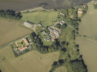 Oblique aerial view centred on the remains of the abbey and church and the farmsteading, taken from the ESE.