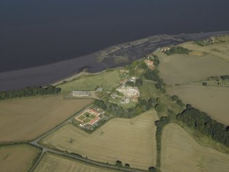 General oblique aerial view centred on the remains of the abbey and church and the farmsteading, taken from the SE.